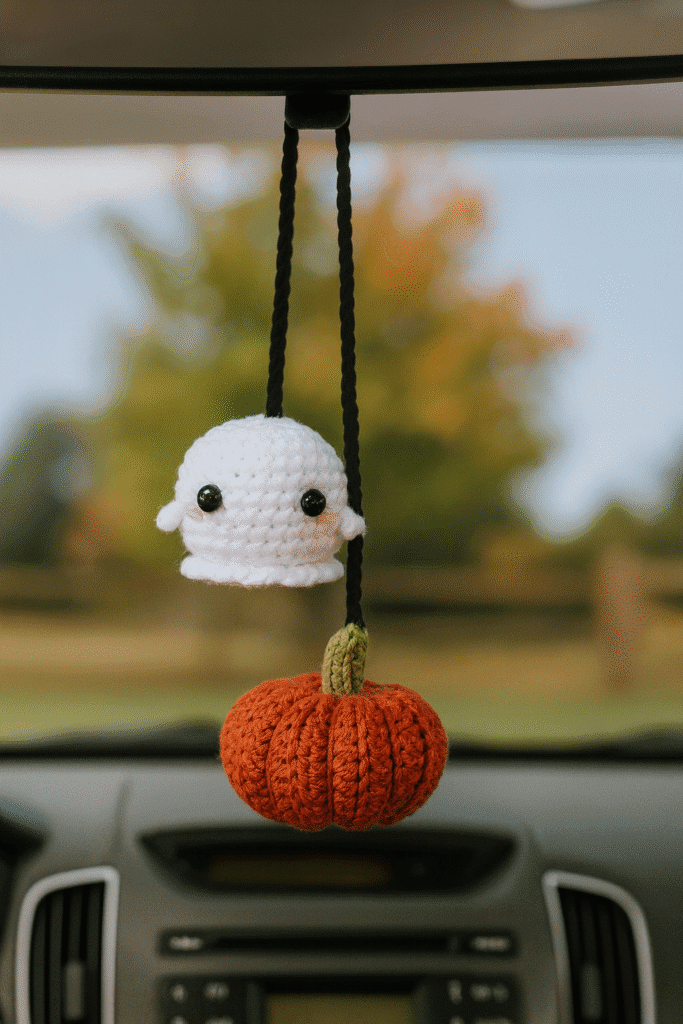 Handmade crochet car charm ghost hanging inside a car during Halloween season