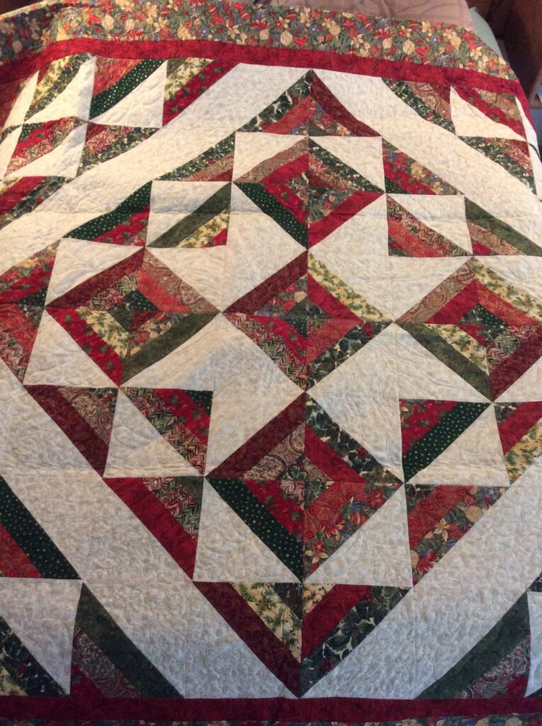 Holiday Jelly Roll Quilt Pattern – Christmas-themed strip quilt with seasonal fabrics