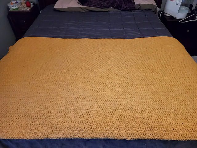 Striped harvest-themed crochet throw in mustard, rust and brown colors