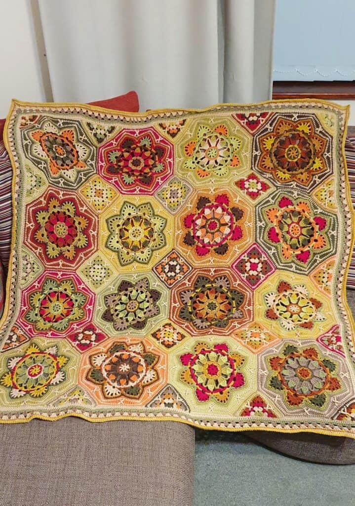 Persian Tiles crochet blanket with warm fall colors, intricate square motifs one of crochet blankets for fall.