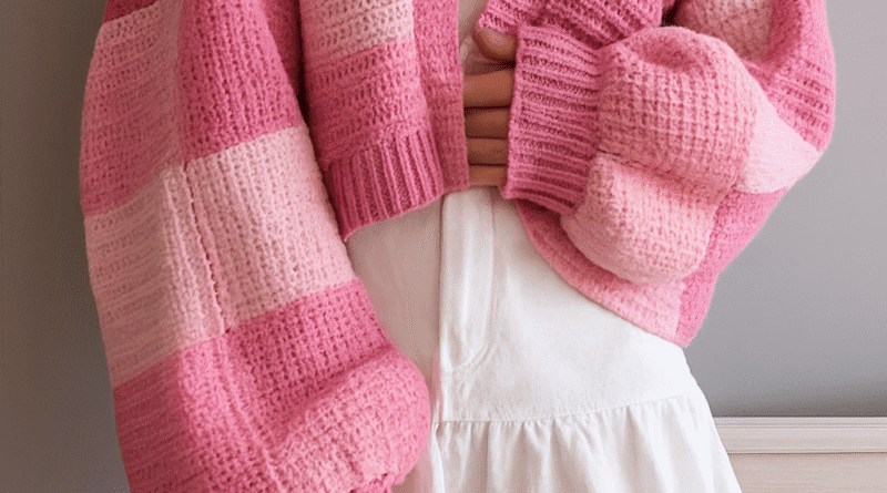 Close-up of granny square details on a patchwork crochet cardigan, showing textured stitches