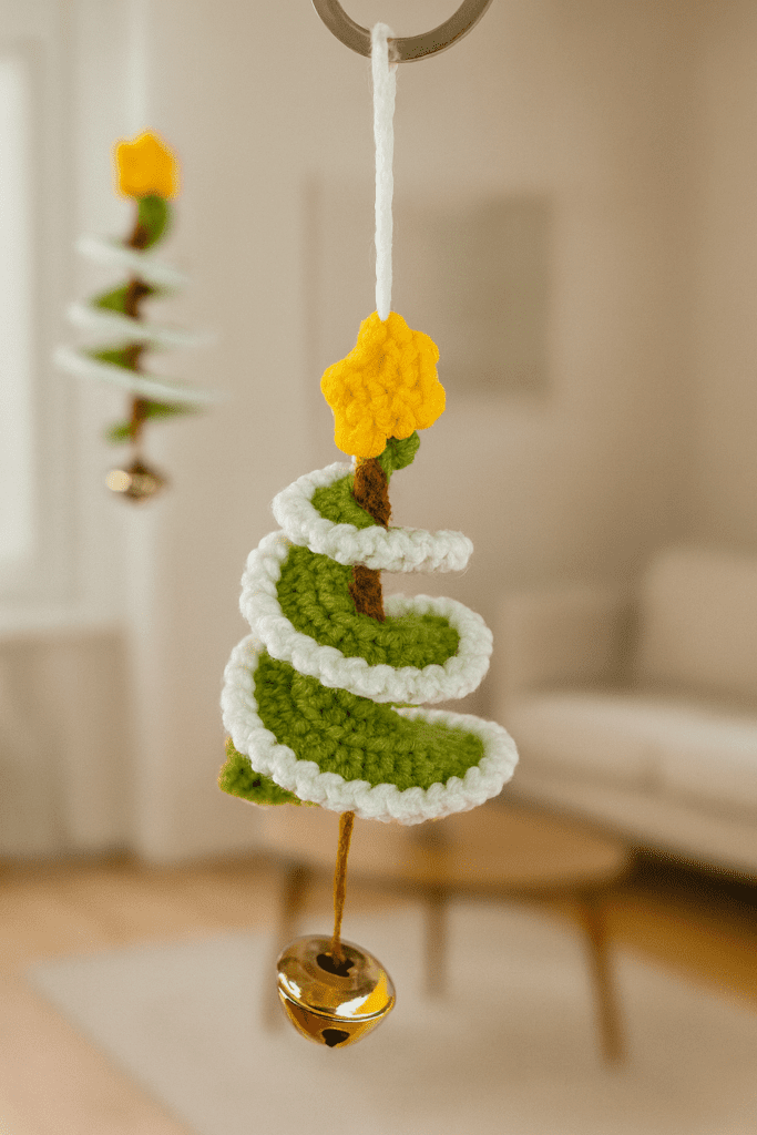 How to crochet a mini Christmas tree using green yarn, showing the finished handmade crochet decoration with a classic cone shape.