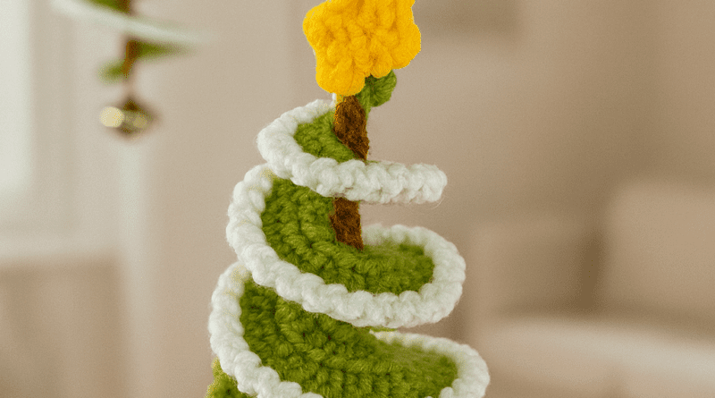 How to crochet a mini Christmas tree using green yarn, showing the finished handmade crochet decoration with a classic cone shape.