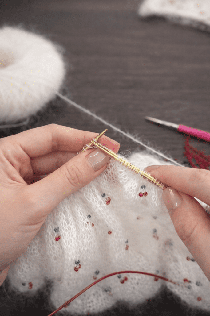 Hand-knitted cherry triangle scarf with chart-based design and clean knitted edges