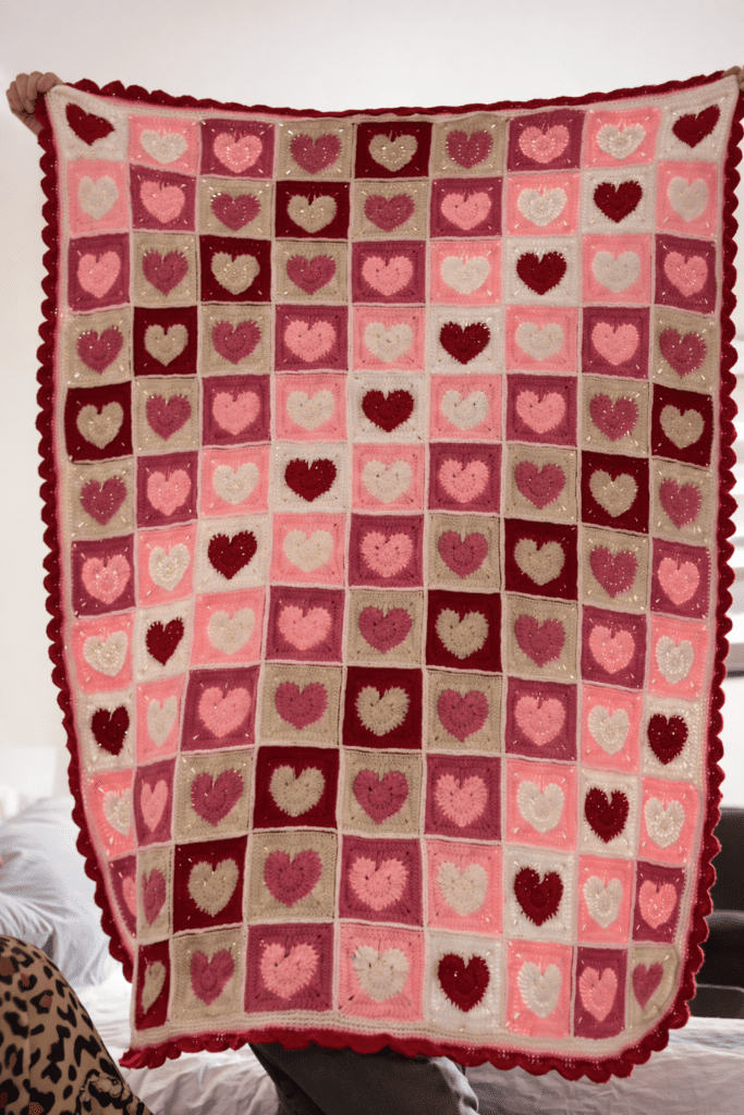 Close-up of a crochet heart granny square a perfect gift for a valentine crochet patterns featuring a textured red heart motif framed by a classic white granny square