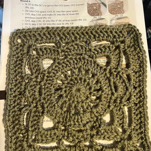 Willow granny square crochet pattern with floral center and open lace stitches in soft pastel colors