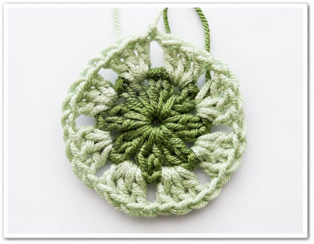 African flower granny square round 3 completed showing 8 petals formed