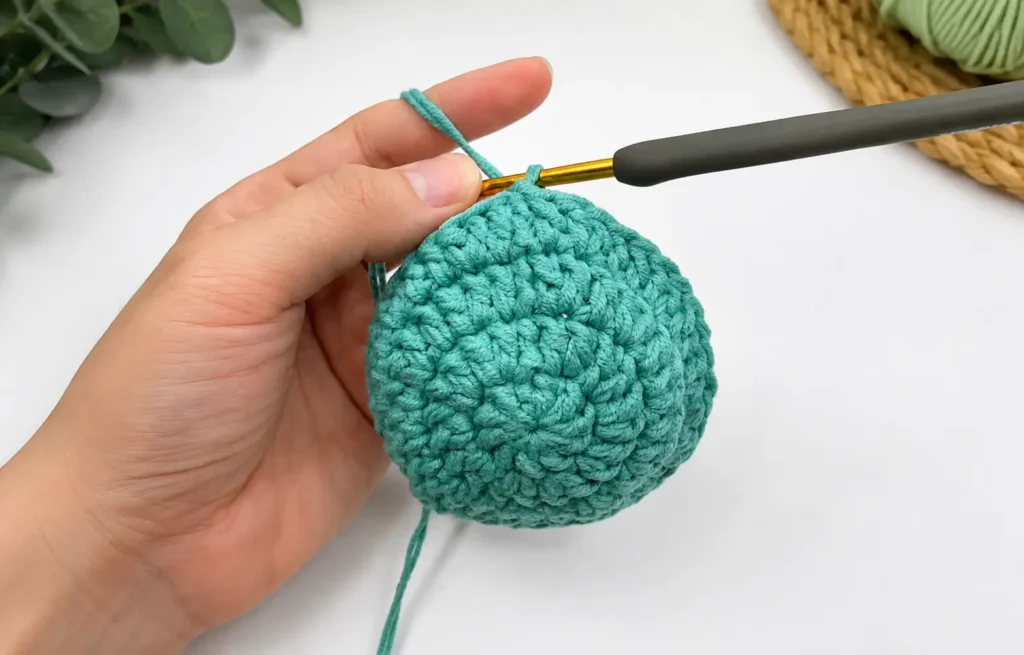 Crochet lizard coaster body — finished green flat circle with reverse single crochet edging, ready for assembly
